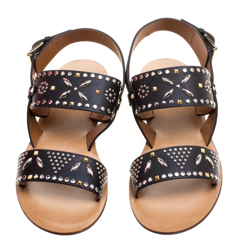 How trendy are these flat sandals from the house of Valentino! They've been crafted from leather and designed with straps that carry stud embellishments. You can wear them with your casual outfits or with dresses.

Includes: Original Box

