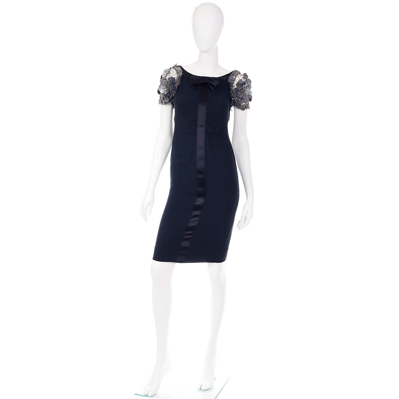 We love Valentino dresses and this one is exceptional. This outstanding dark, midnight blue silk crepe evening dress is actually sleeveless but it has stiffened net cap applique floral sleeves that are entirely beaded. We have a coat from the