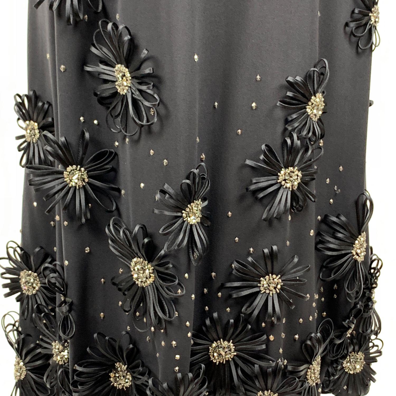 Elegant VALENTINO silk embellished evening maxi dress in black color. Beautiful fabirc flowers applique with rhinestones and beads accents. Straight neckline with built-in bra. Spaghetti strap. Side zip closure. Very light silk lining. Size is not