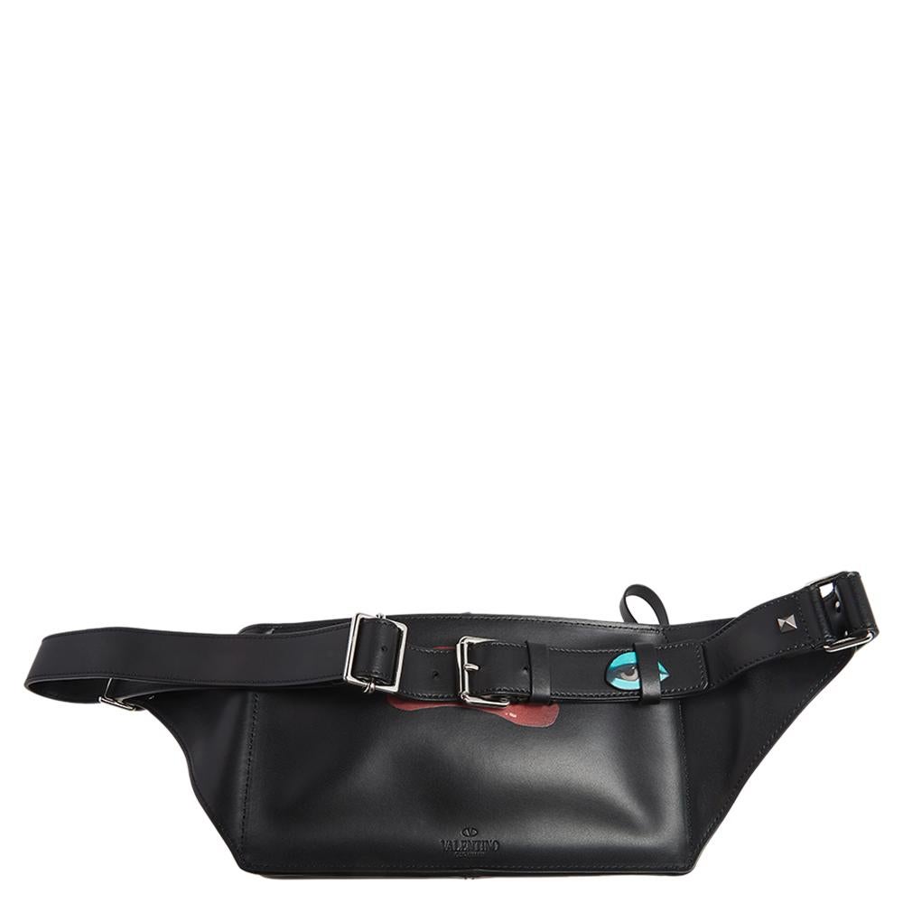 This belt bag from Valentino is exquisite. It has been crafted using quality material. It is stylish and extremely well-made. It has a flame and logo print on the front, a spacious interior for your belongings and a belt to wear on your