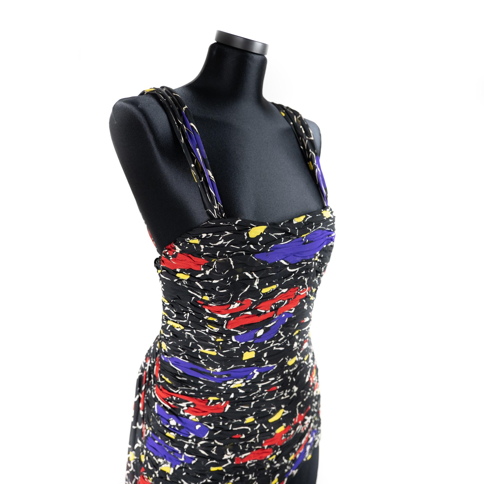 Valentino Boutique Night Dress. Circa 1979.
The composition label is missing.
This Valentino dress is made from a double layered silk chiffon designed with a flower print of blue, red and black. The bodice of the dress is heavily ruched accentuating