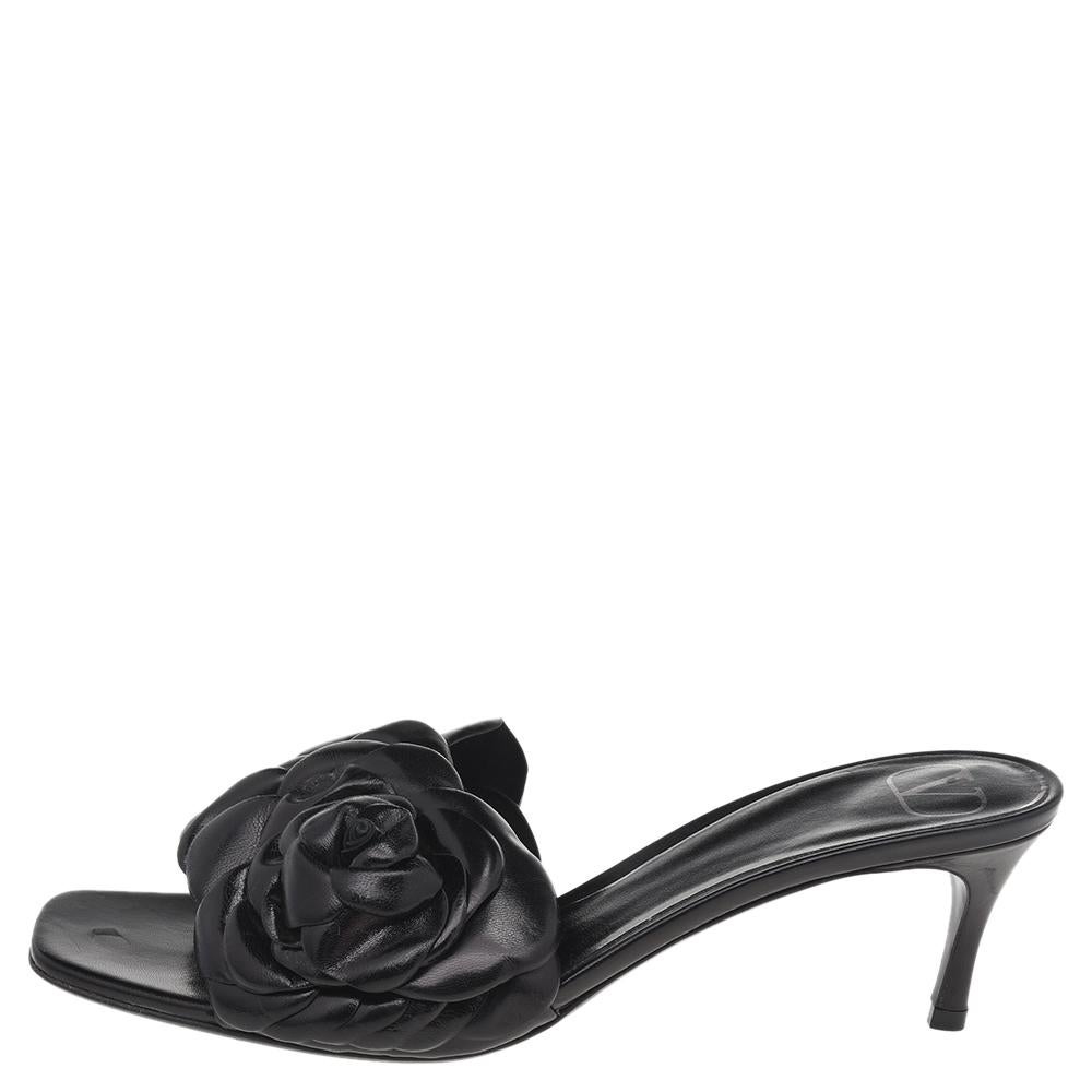 Treat your feet to the best of things by choosing these stunning slide sandals from Valentino! The black-hued flats come crafted from leather, and detailed with large flowers on the uppers.