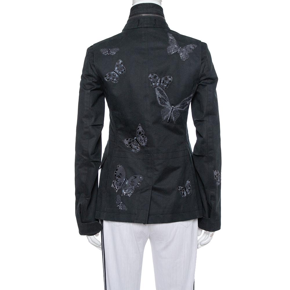 Keep it stylish and elegant with this stunning jacket from the house of Valentino. Made from a silk blend, the jacket is adorned with butterfly appliques, flap pockets, and buttoned closure. There is a chain detail on the collars, and long sleeves