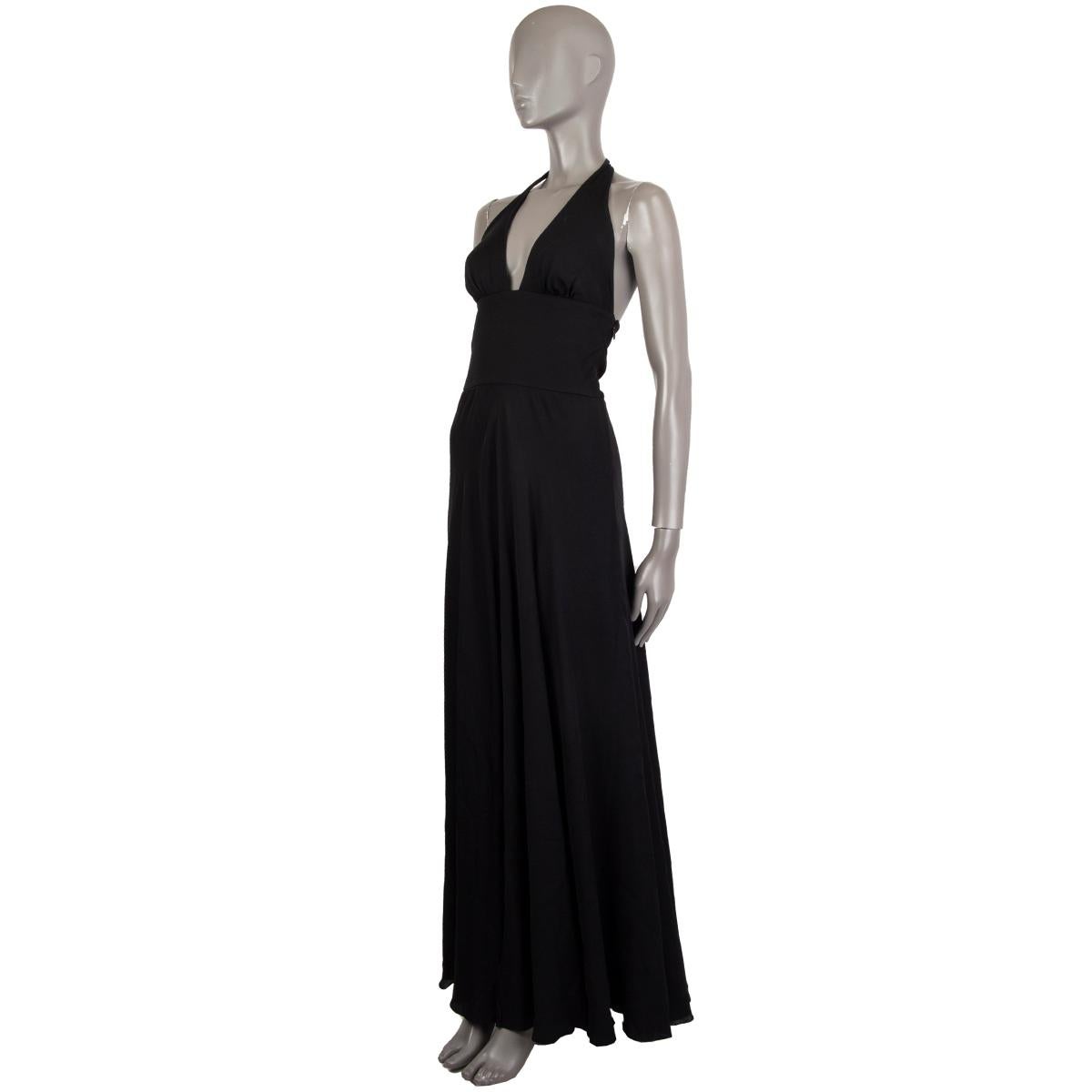 Valentino long evening dress in black missing tag (probably silk blend) with a slit in the front, halter neck closes two buttons and snap-buttons, deep cut-out and close fit around the waist, A-line skirt and an open back. Lined in black fabric