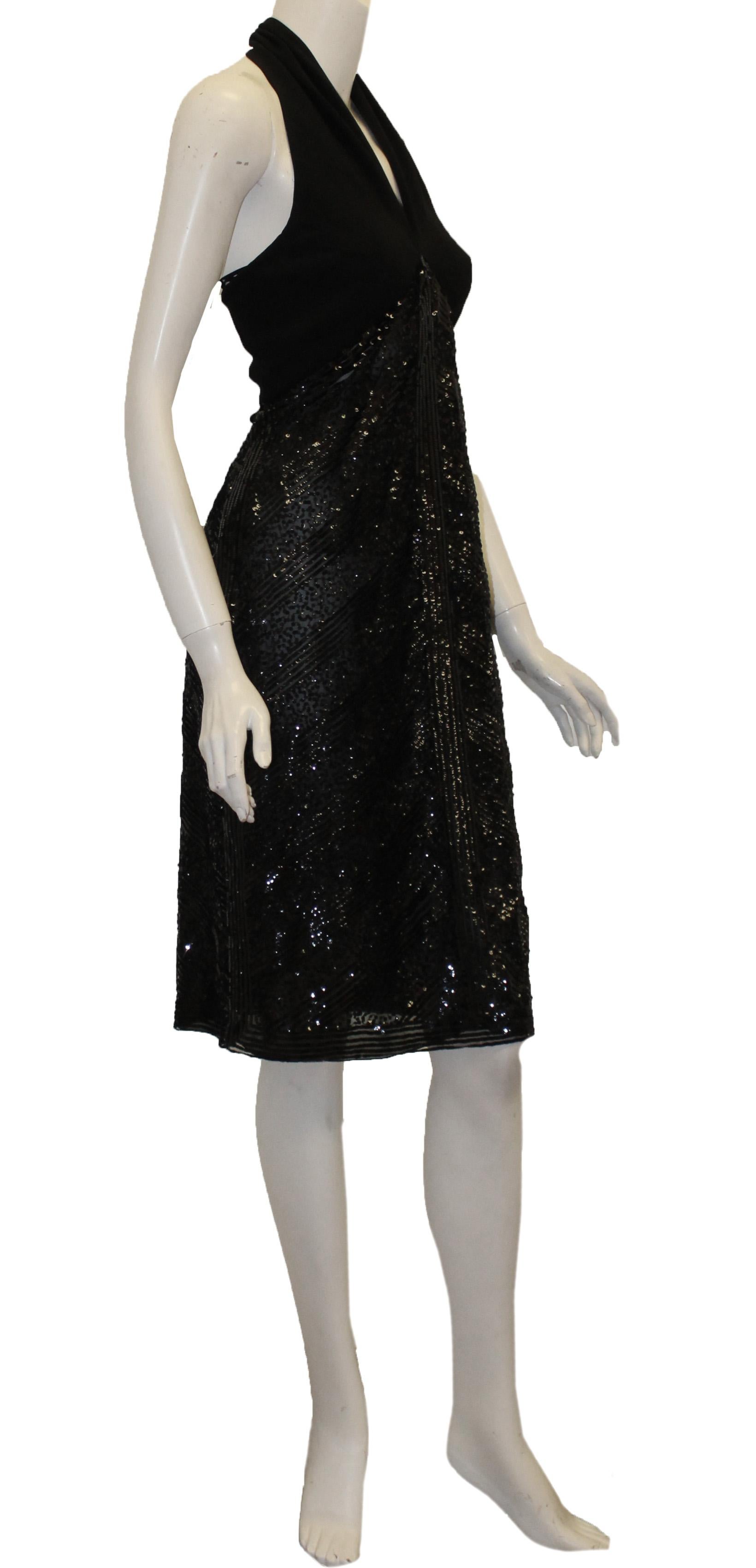 Valentino black halter cocktail sequined dress is accentuated by a plunging neckline and open back.  This dress is tied at back with 3 buttons at back of the neck.  Side zipper closure.  Sequin embroidery features abstract chevron design both at