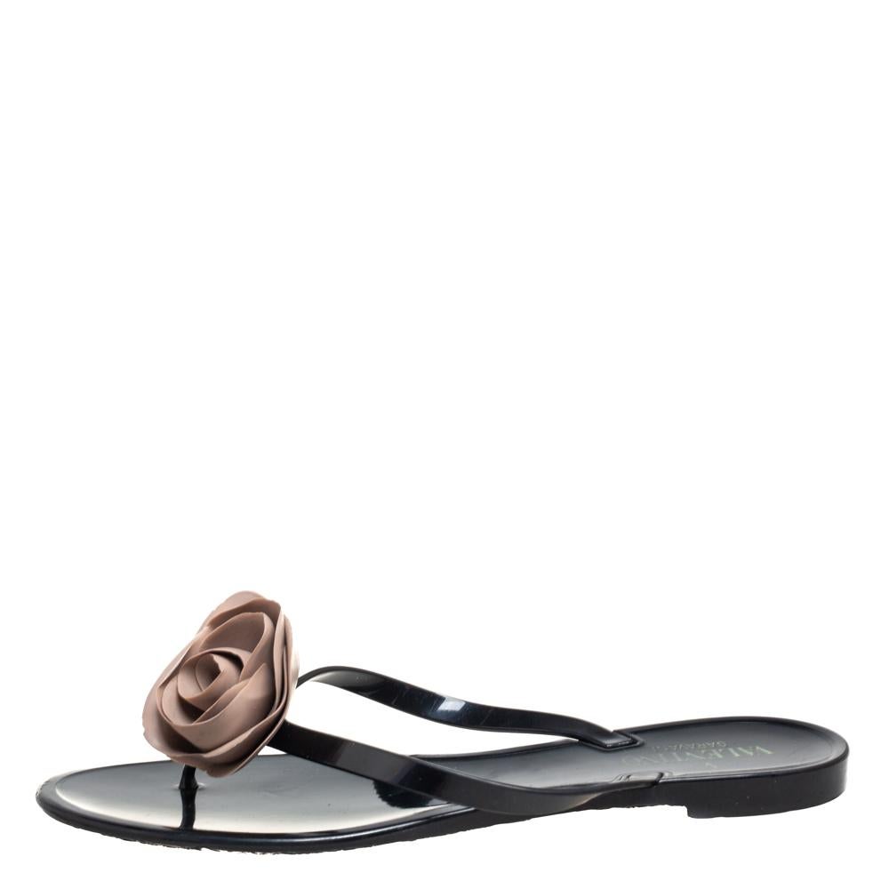 Flaunt comfortable style with these beautiful jelly flats from Valentino. These gorgeous black flats have a thong design with a rose motif highlighting the uppers. They are appealing and water-friendly.