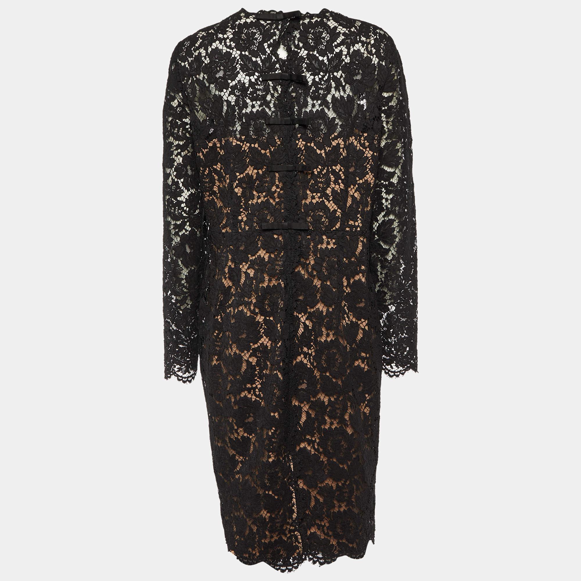 The Valentino dress exudes timeless elegance with its intricate lace detailing and form-fitting silhouette. Crafted with precision, it gracefully accentuates curves while the delicate long sleeves add a touch of sophistication, making it perfect for