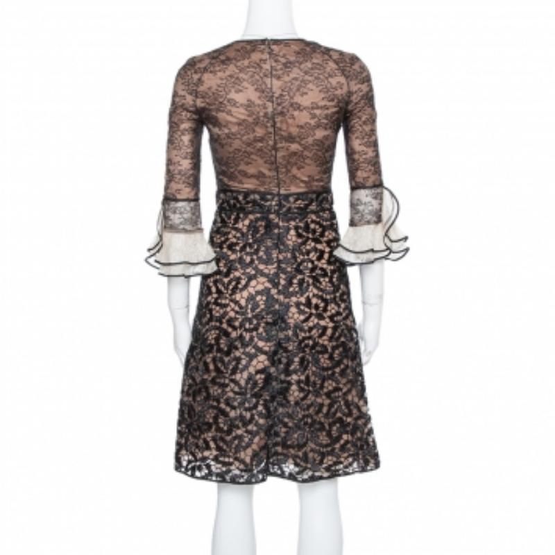 Beautifully tailored to impart an elegant appeal, this Valentino dress is a true example of the brand's sophisticated designs. The lace fabric and crochet dress has flare cuffed sleeves, a back zipper, and a round neckline.