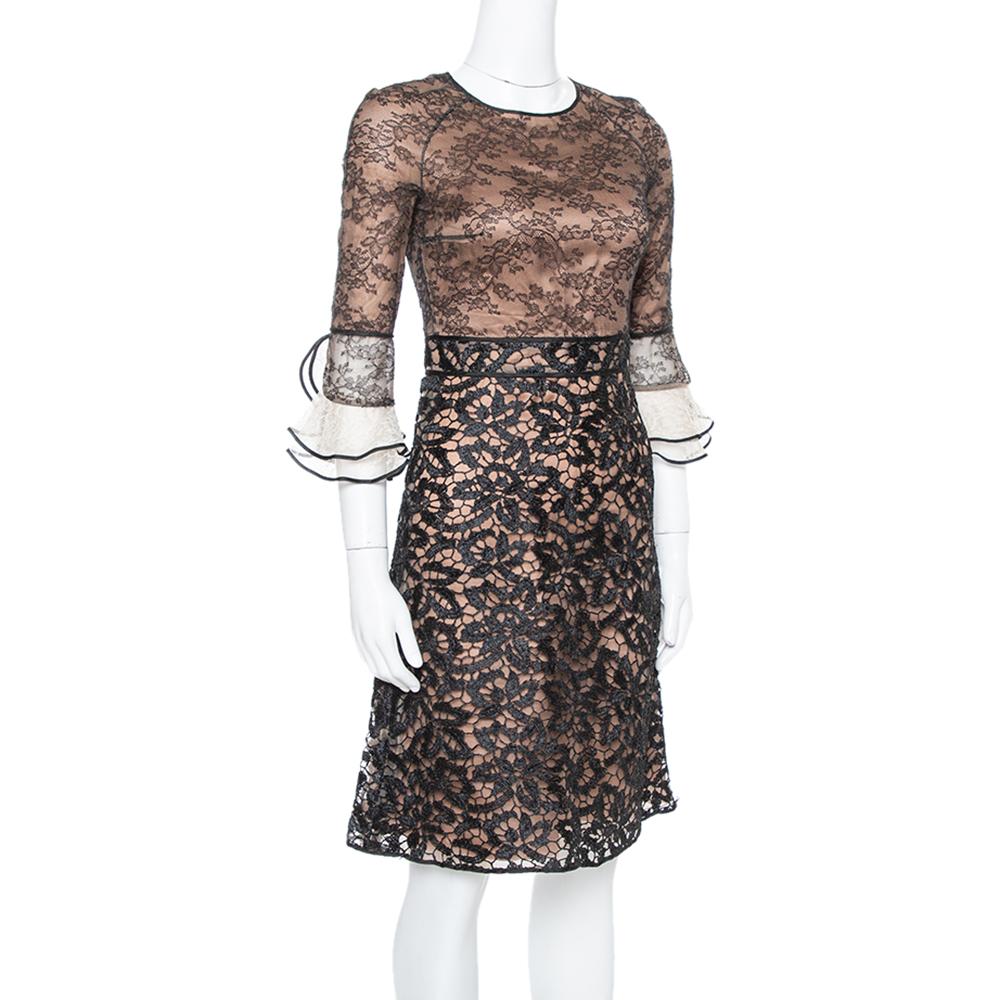 Beautifully tailored to impart an elegant appeal, this Valentino dress is a true example of the brand's sophisticated designs. The lace fabric and crochet dress has flare cuffed sleeves, a back zipper, and a round neckline.

