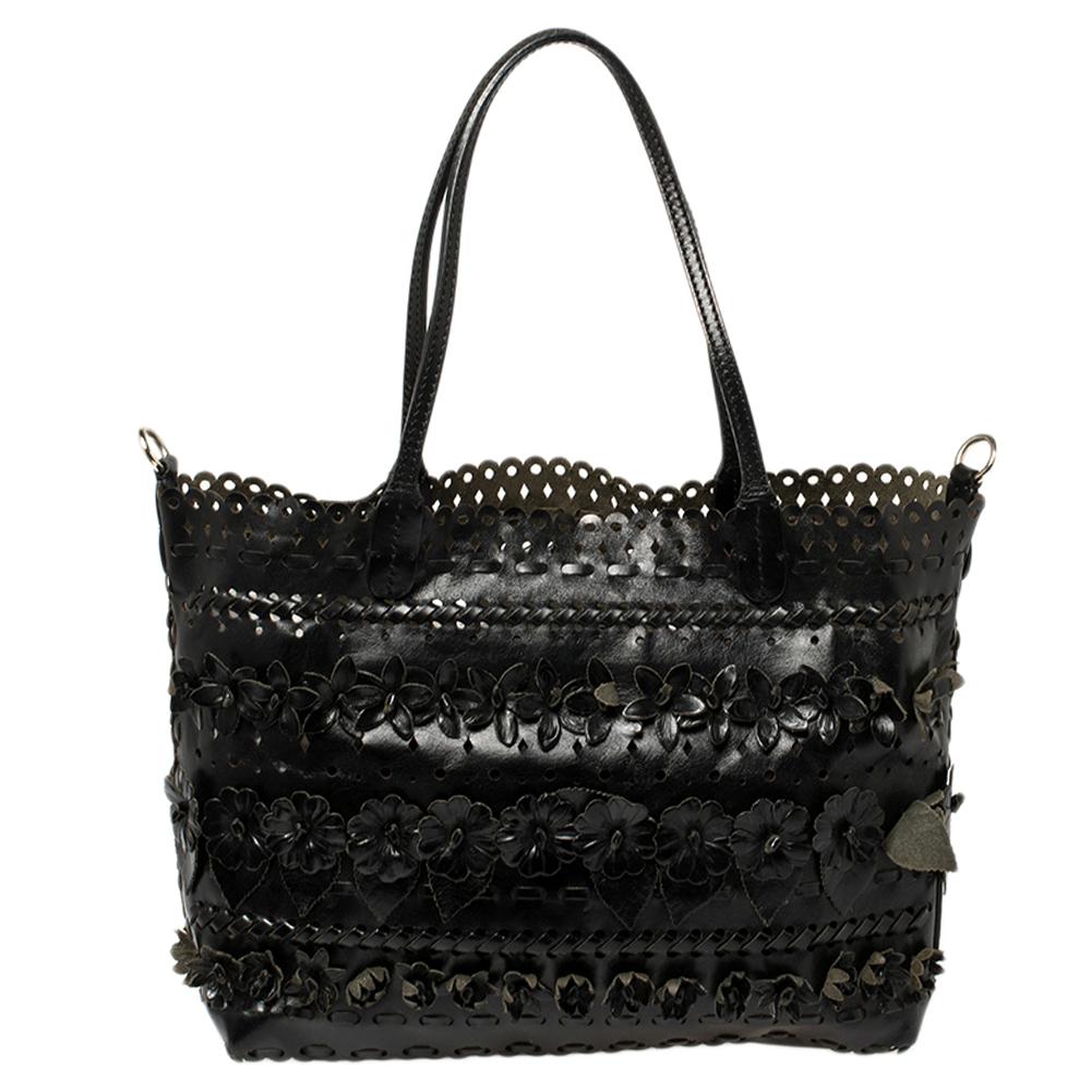 Valentino is known to bring out unique and one-of-a-kind pieces year after year, and this bag is indeed one of them! It is crafted beautifully using leather, then adorned with floral appliques and intricate laser cuts all over. The tote comes