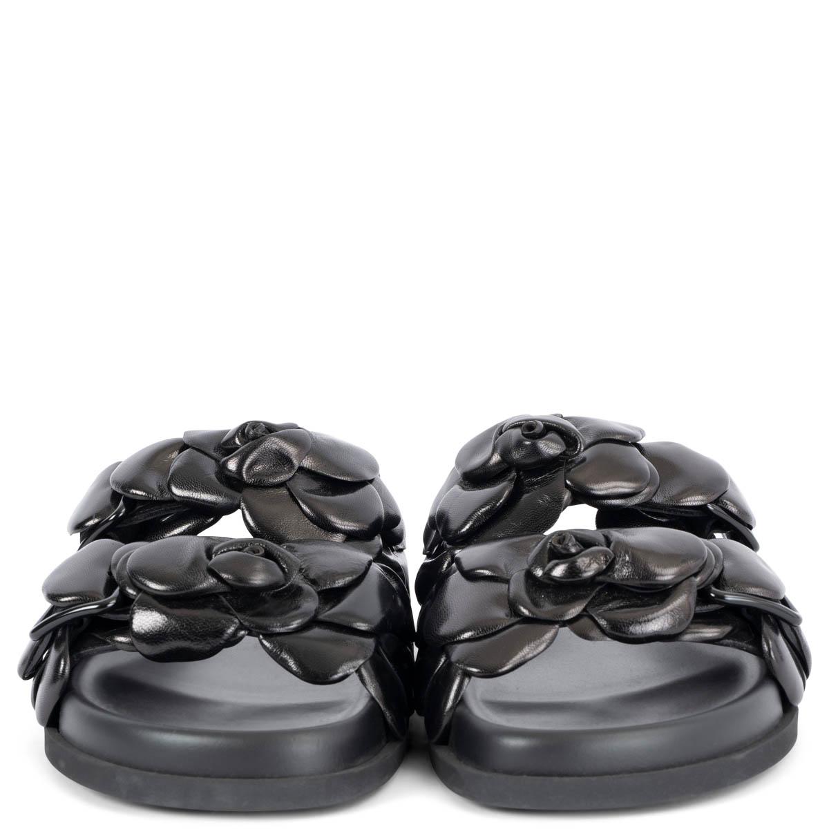 100% authentic Valentino Garavani Atelier Shoe 03 Rose Edition black kidskin flat slide sandal with footbed. Upper embellished with different sized leather petals, creating a 3D rose detail. Finished with a rubber sole. Brand new. Come with dust