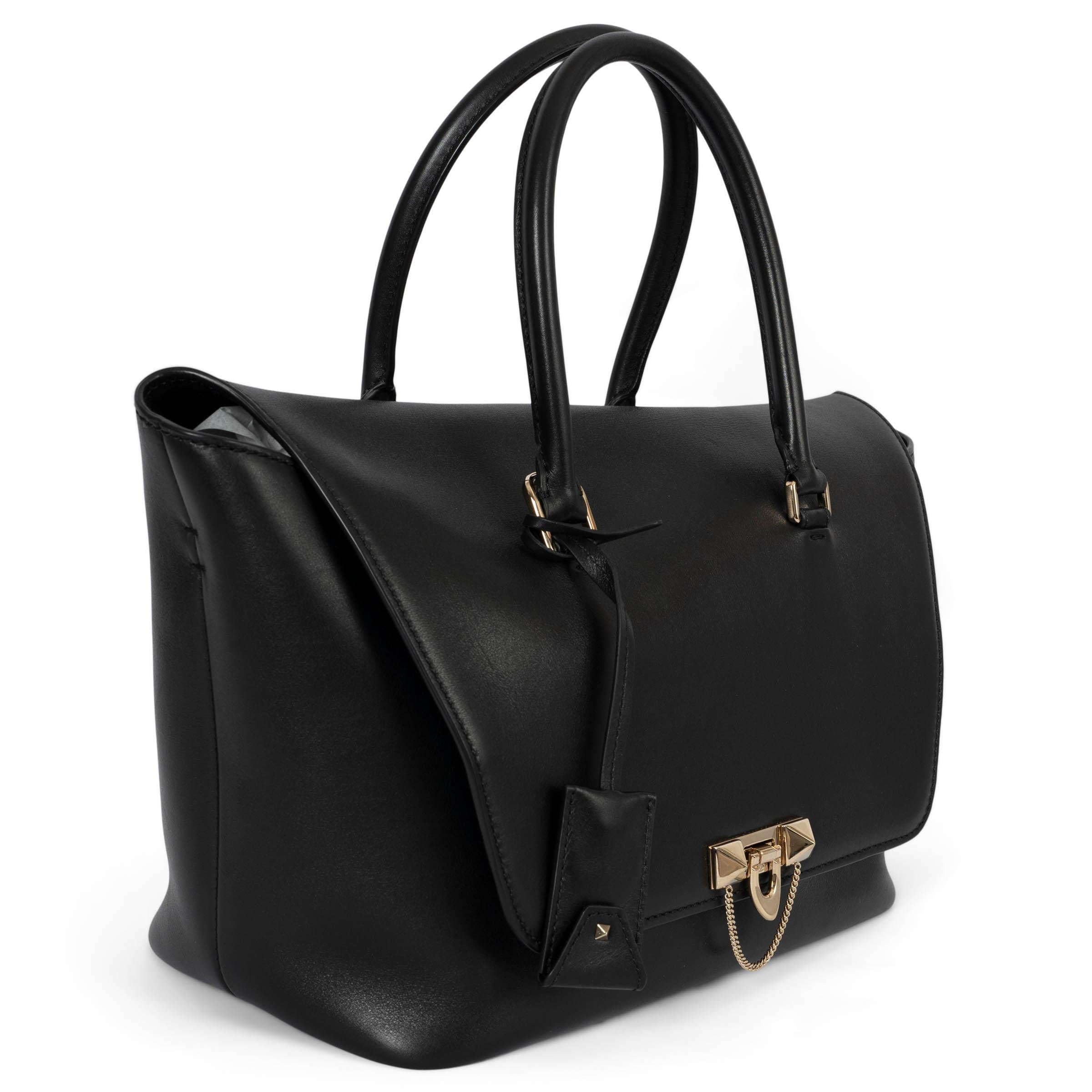 100% authentic Valentino Large Demilune shoulder bag in black smooth calfskin embellished with a light gold-tone rockstud lock and detachable shoulder-strap. Lined in black suede with one zipper pocket against the back and two open pockets against