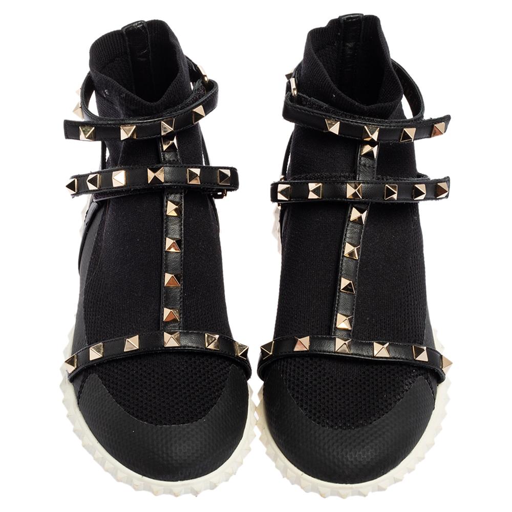From one of the most coveted creations of the brand, these Rockstud sock sneakers from Valentino are everything you need to look chic. They are created using black leather and knit fabric with the signature gold-toned Rockstud embellishments