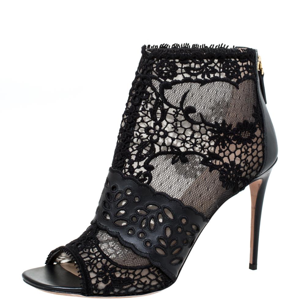 Deliver the most unforgettable looks in these black booties from Valentino! From their shape and detailing to their overall appeal, they are utterly mesmerizing. The booties are crafted from leather and lace. They are complete with peep-toes,