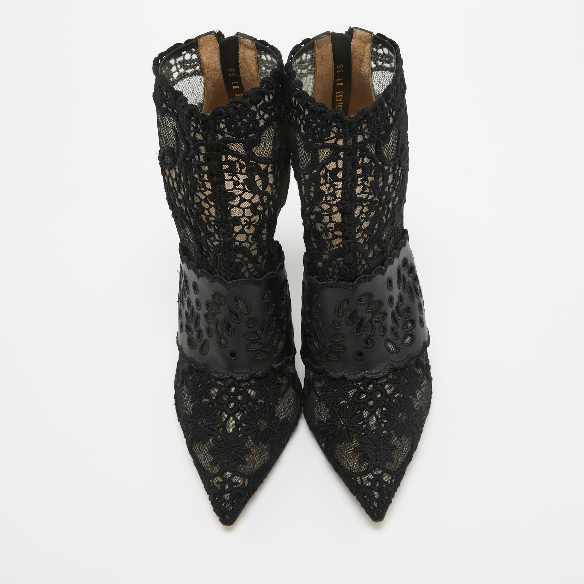 Deliver the most unforgettable looks in these black booties from Valentino! From their shape and detailing to their overall appeal, they are utterly mesmerizing. The booties are crafted from leather and lace. They are complete with pointed toes,