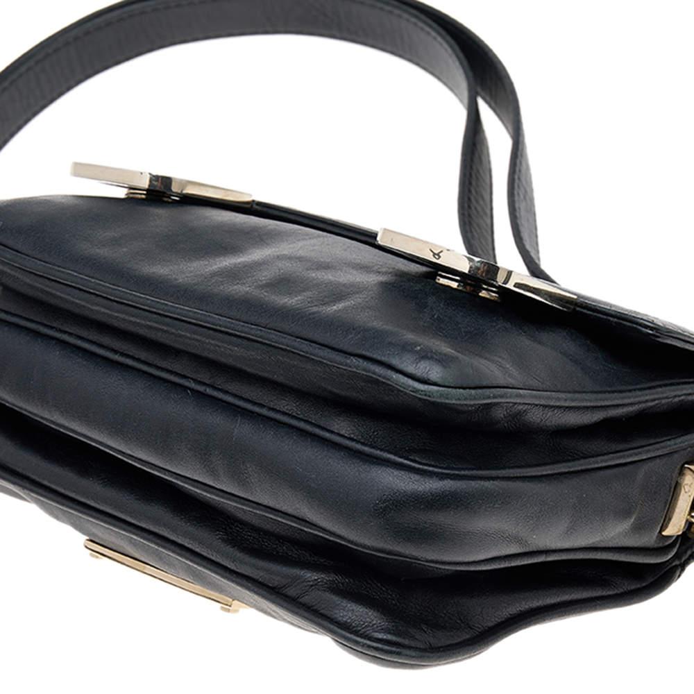 This stunning shoulder bag from the House of Valentino grants you complete functionality without compromising on style or luxury! It is fashioned using black leather. The front features embellishments. It has gold-tone hardware, a roomy fabric-lined
