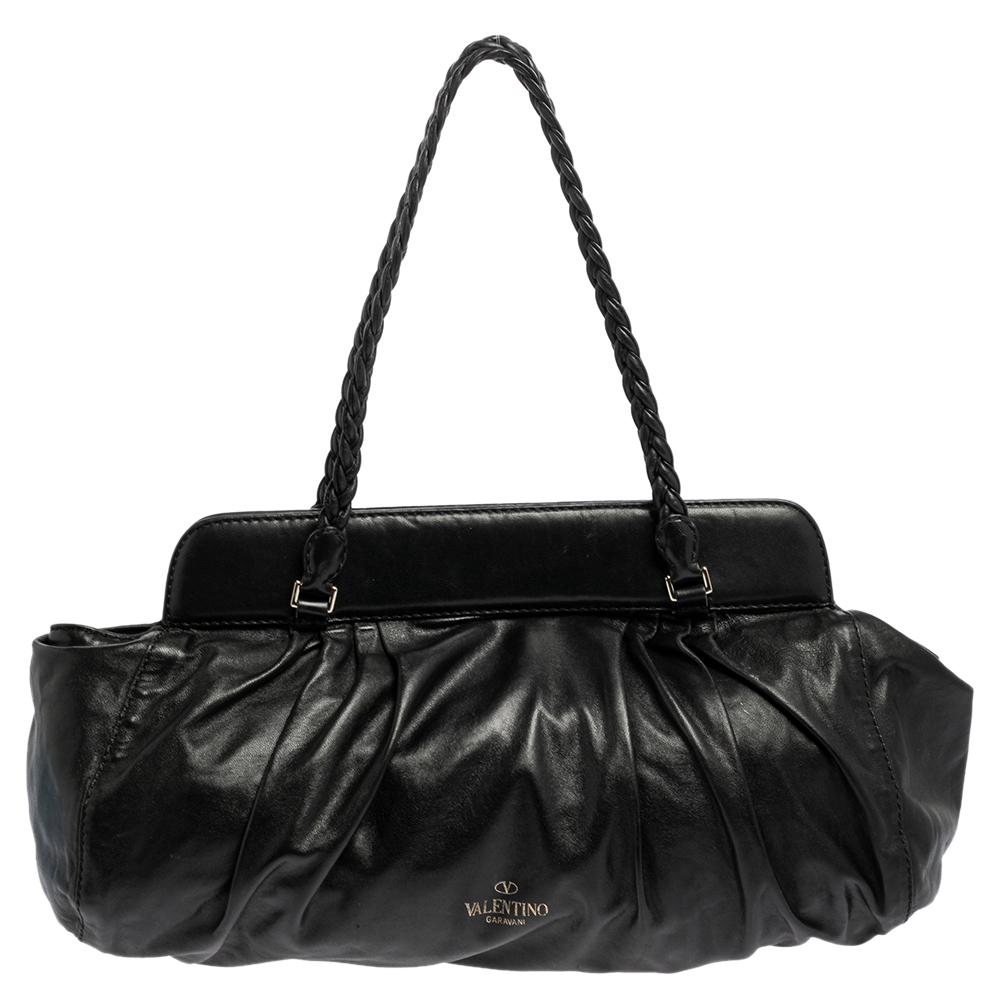 Valentino handbags are known for their unique designs that emanate the label's feminine verve and immaculate craftsmanship that makes their creations last season after season. Crafted from black leather, the satchel is elevated with floral