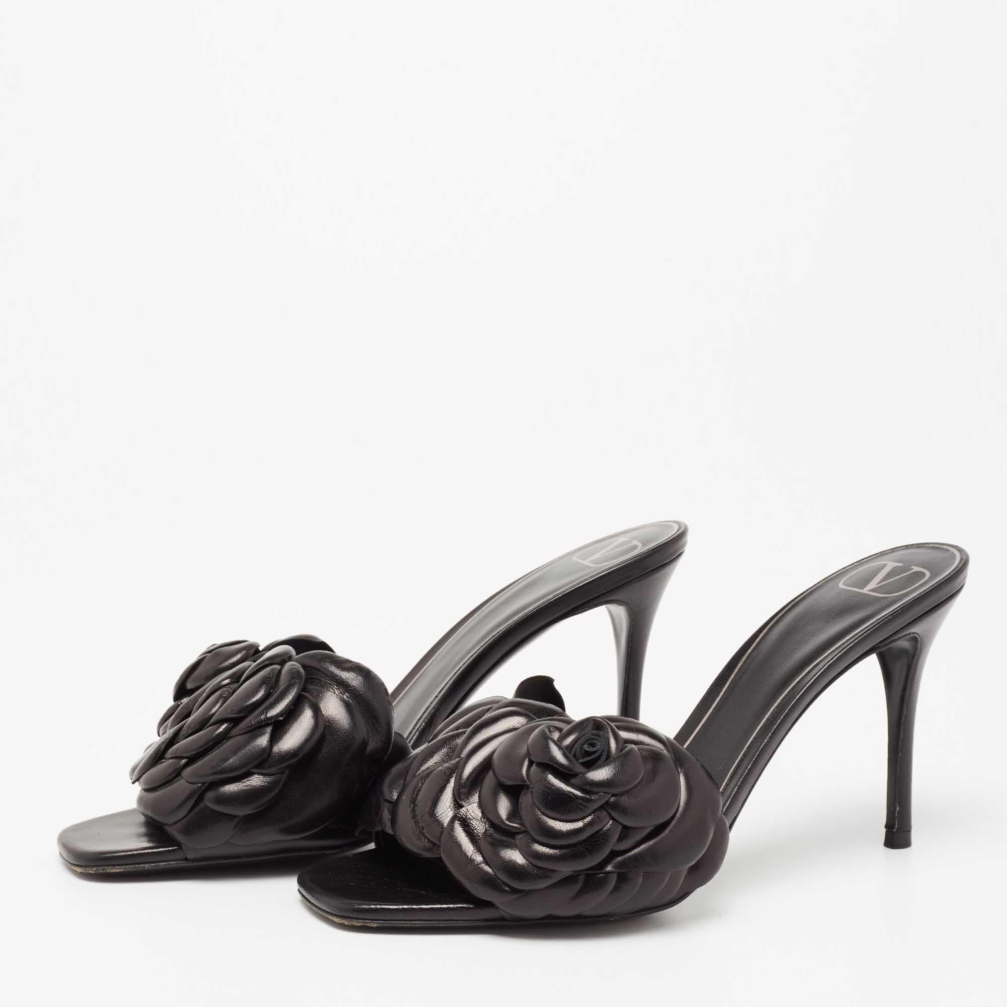 These Valentino black sandals come bearing the rose—a symbol of timeless beauty present in many of the brand's designs. These slides, constructed using leather, feature a 3D rose detail on the uppers with varying sizes of leather petals. The sandals