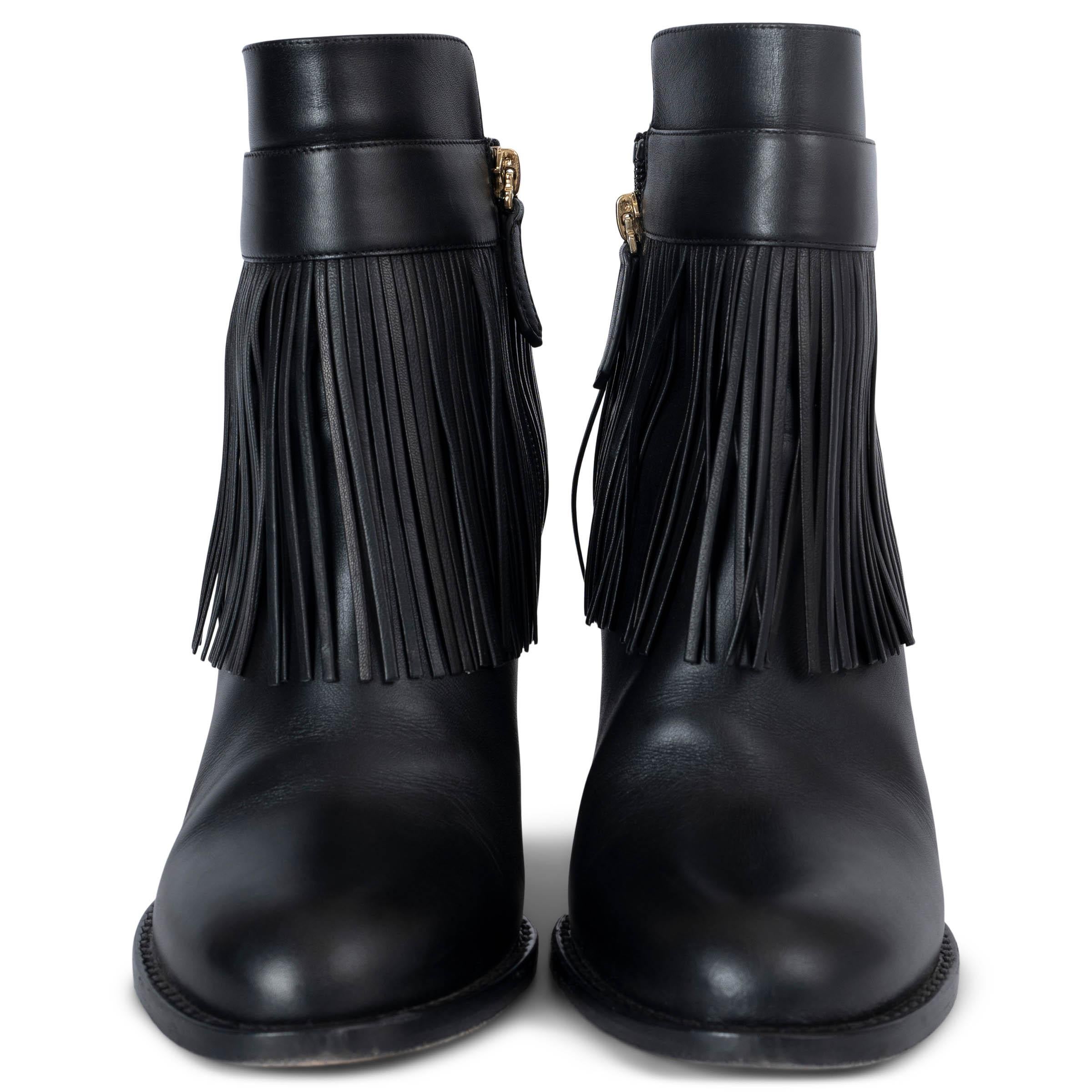 These 100% authentic Valentino ankle boots are crafted from black leather, featuring a stylish fringe trim and a classic round toe. They open easily with a zipper on the inside, offering both elegance and practicality. These Valentino ankle boots