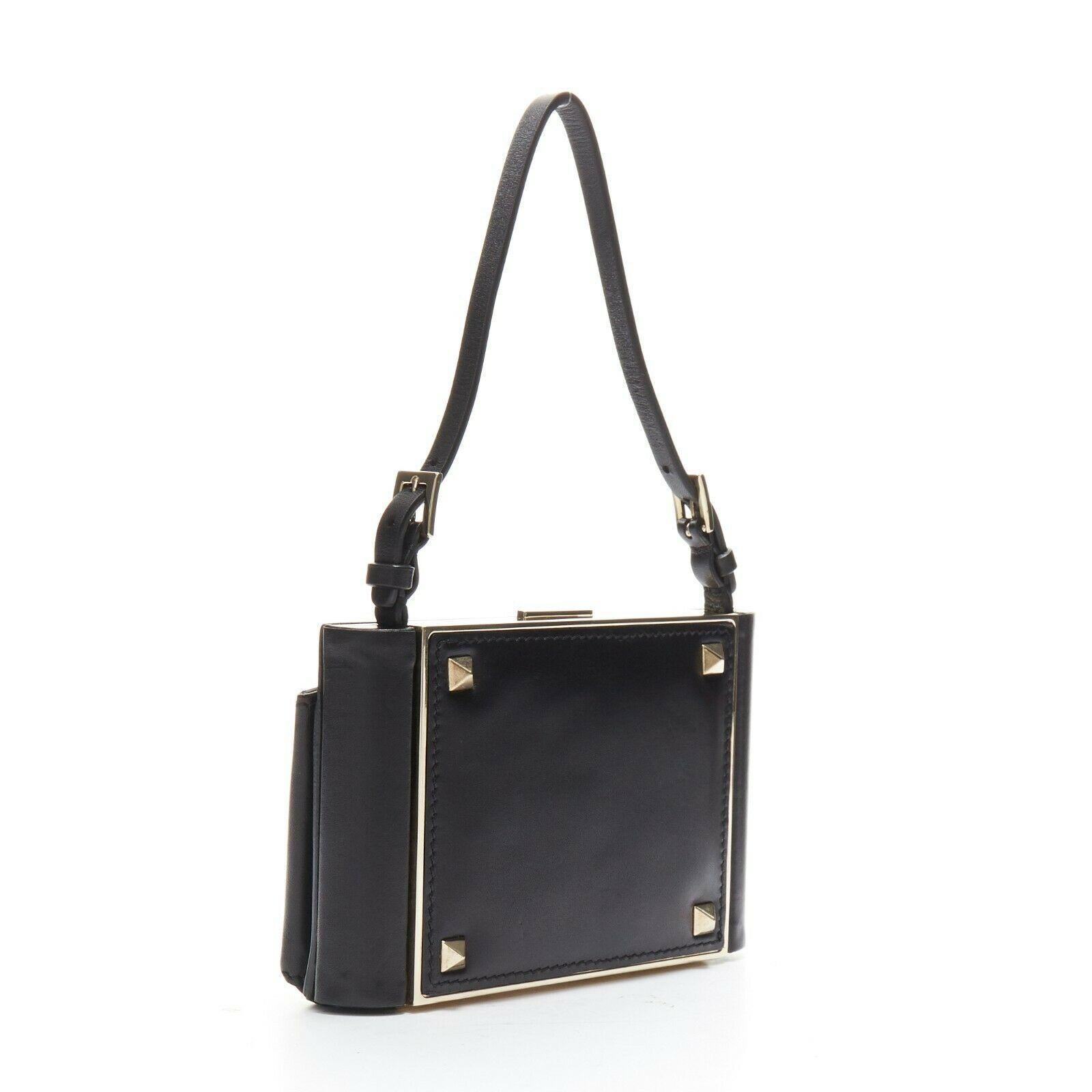 VALENTINO black leather gold Rockstud metal frame minaudiere clasp clutch bag 
Reference: TGAS/A03355 
Brand: Valentino 
Model: Valentino Rockstud 
Material: Metal 
Color: Black 
Closure: Clasp 
Extra Detail: Black leather upper. Gold tone metal