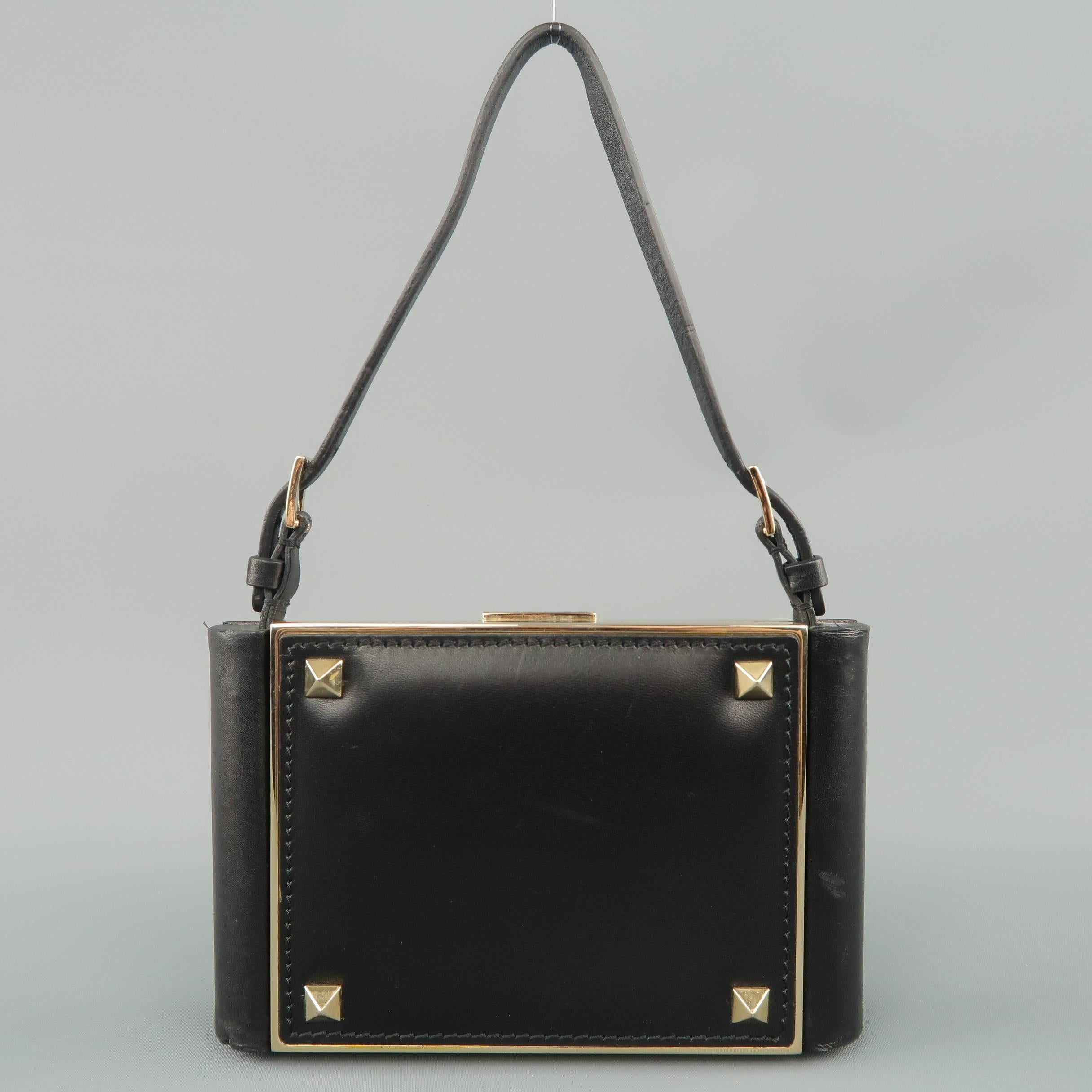 Mini VALENTINO evening purse comes in black leather with gold tone studs, a gold tone metal clasp top closure, back snap pocket, and gold tone metal chain crossbody strap. Includes optional short handle strap. Made in Italy.
 
Excellent Pre-Owned