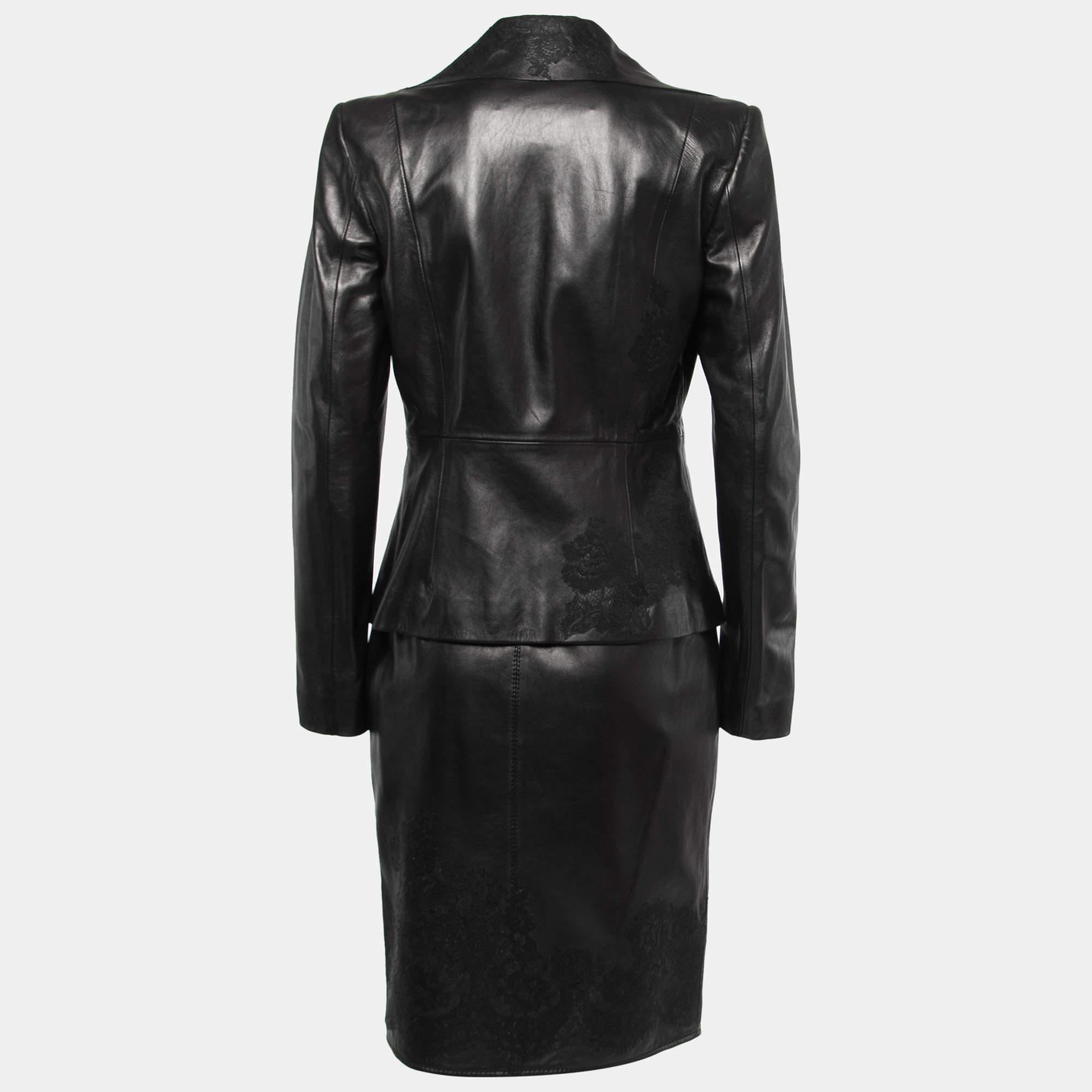 The Valentino Black Leather Lace Trimmed Jacket Skirt Set exudes timeless elegance. Crafted from luxurious black leather, the jacket features delicate lace trim detailing, adding a touch of femininity to the edgy design. The matching skirt completes