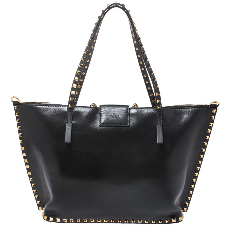 The Hype tote by Valentino has a modern design. This one here is crafted from smooth leather and designed with clean Rockstud trims, two handles and dual zippers that feature red leather pulls. The interior is spacious enough to assist you on all