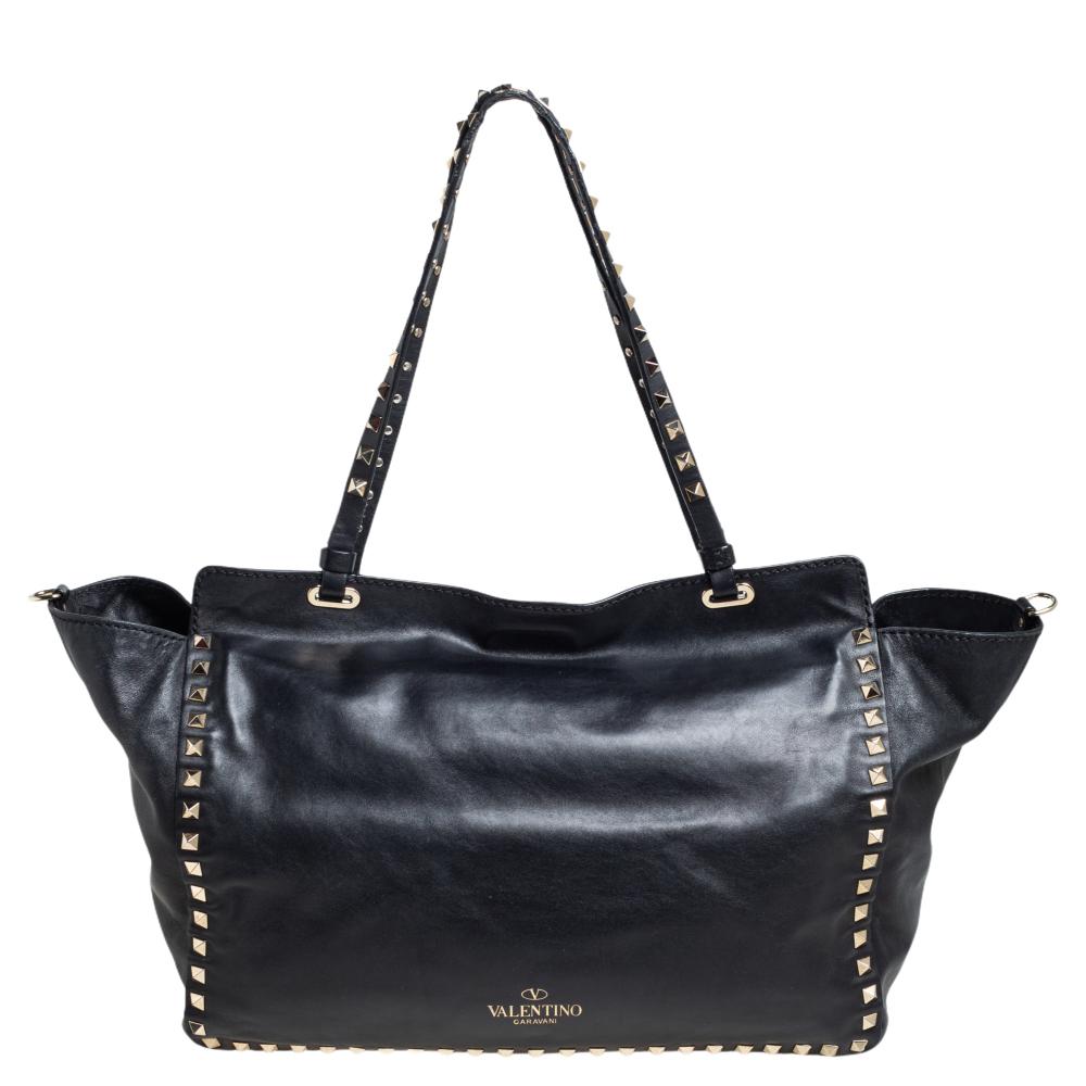 Valentino brings you this super-stylish tote cast in a design that transcends trends. It has a classy black leather exterior decorated with signature Rockstuds. The tote is complete with a spacious fabric interior, two top handles, and a shoulder