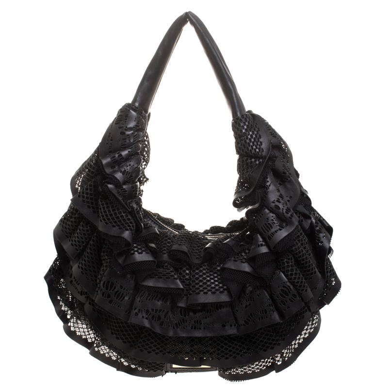 Show your elegant fashion sense by carrying this Valentino hobo bag. Crafted using black leather with mesh ruffles, this bag features a single handle and gold-tone hardware. The top zipper opens into a nylon-lined interior sized perfectly to hold