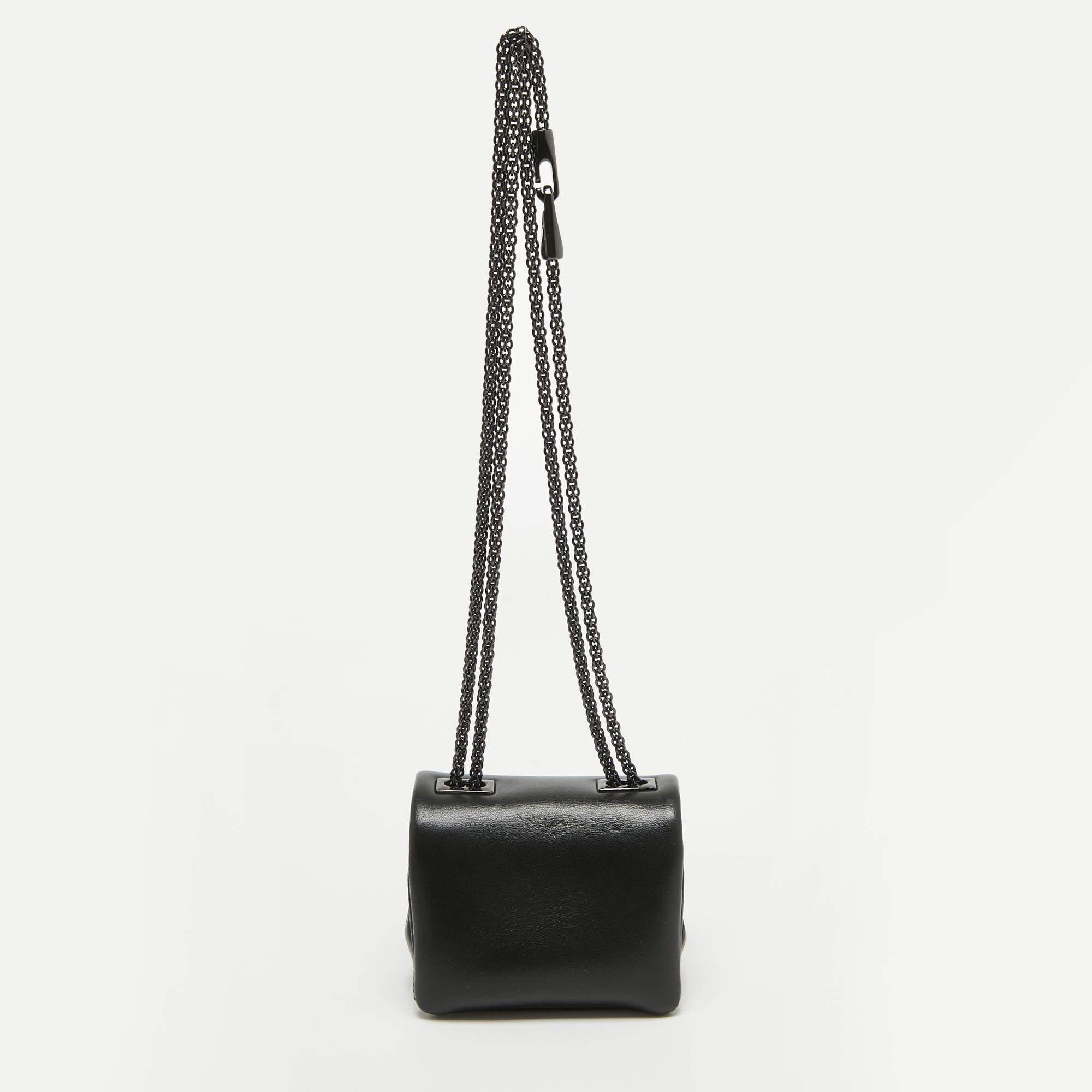 If you're a fan of micro-sized bags, this Valentino One Stud bag is for you. It is fashioned in black leather and punctuated by a single pyramid stud.

Includes: Original Dustbag, Original Box, Info Booklet

