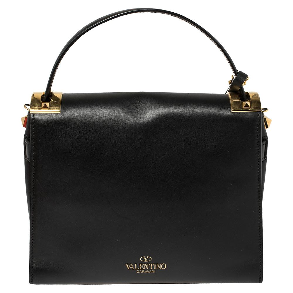 Catch admiring glances when you carry this My Rockstud bag from Valentino! Crafted well, the black bag has a top handle, a shoulder strap, and it features the iconic Rockstuds at the bottom and a leather tag to the front. The front flap opens to a