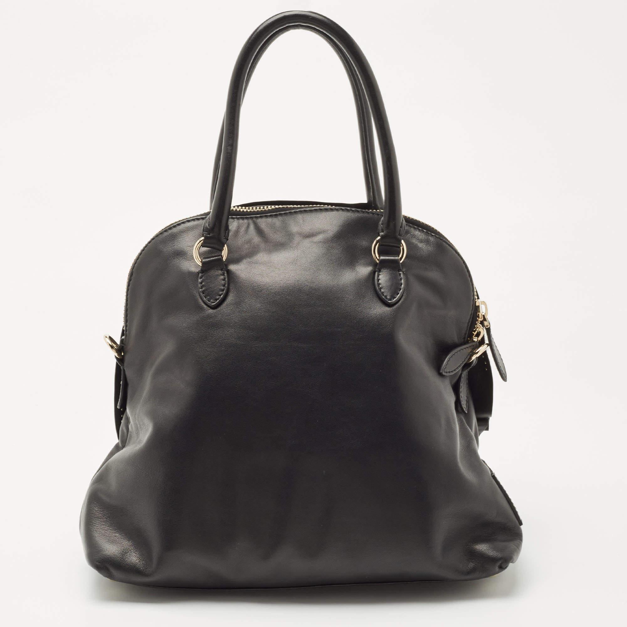 Bags like these are hard to come by, so quickly grab one when you can! Crafted from leather, this bag by Valentino features a beautiful rose detailing on the front. Equipped with dual handles, it has a satin-lined interior sized to hold your daily