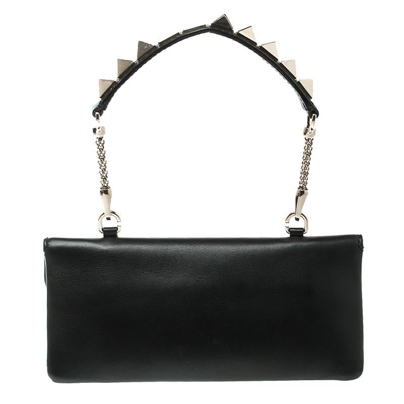 Give an edge to your outfit and accessorise it with this clutch from the house of Valentino. Crafted from black leather the bag features a rectangular shape and a push lock closure. The leather lined interior is sized to fit your necessities. The