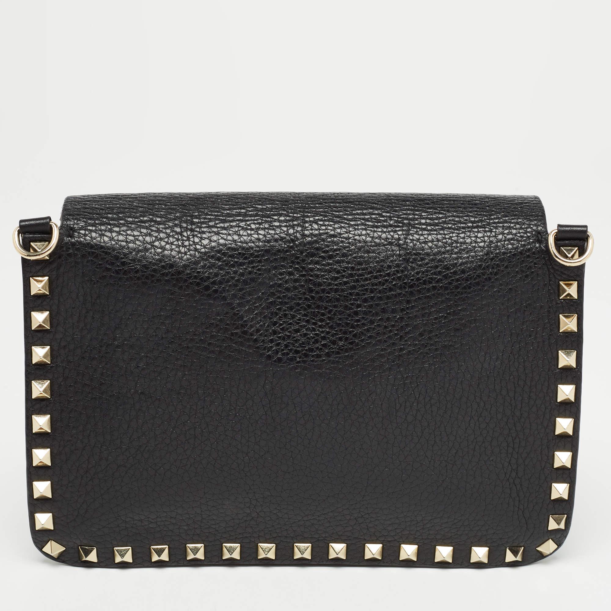 This Rockstud crossbody bag from the house of Valentino is a beauty. Crafted from black leather, the exterior features gold-tone studs and the full flap opens to a suede-lined interior for your essentials. This exquisite bag is perfect for a host of