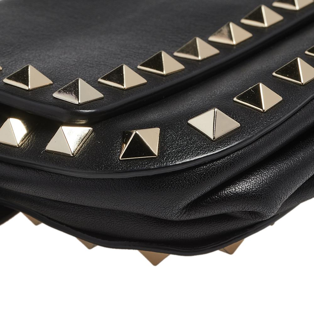 This Valentino belt bag blends a modern silhouette with an iconic House code—Rockstud. Crafted from black leather, the belt bag is styled with gold-tone studs on the exterior. The bag has a fabric interior and an adjustable waist belt.

Includes: