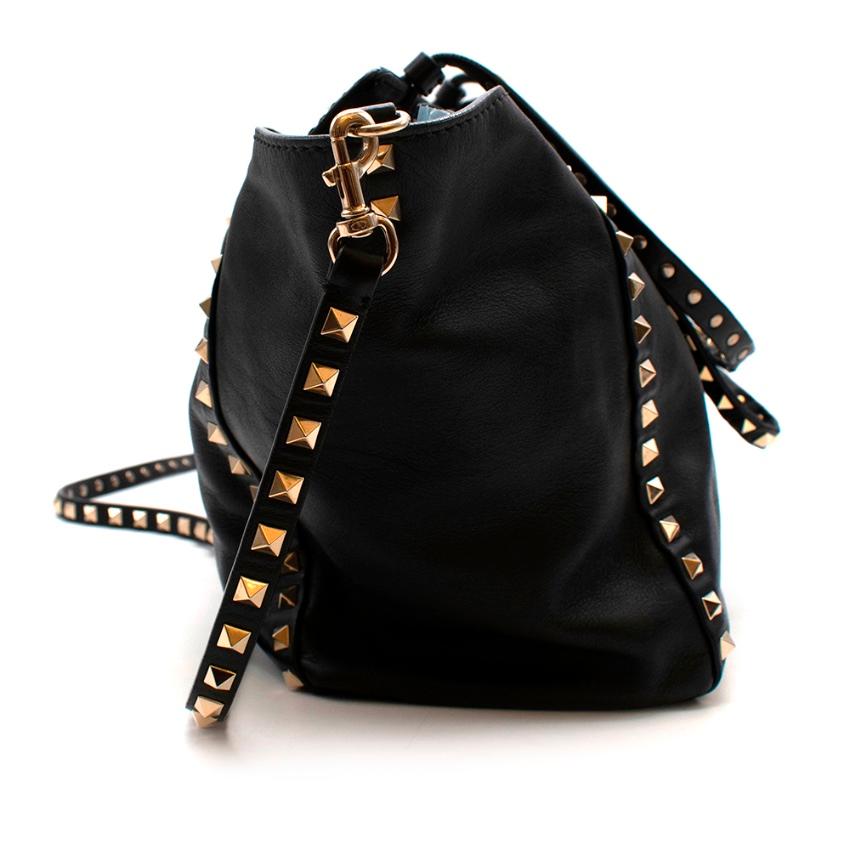 Valentino Black Leather Rockstud Medium Tote

- Made of luxurious super soft leather 
- Metal flip lock closure 
-Iconic rockstud embellishments 
- Detachable shoulder strap. 
- Interior: flat zip pocket and flat double open pocket. 
- Protective