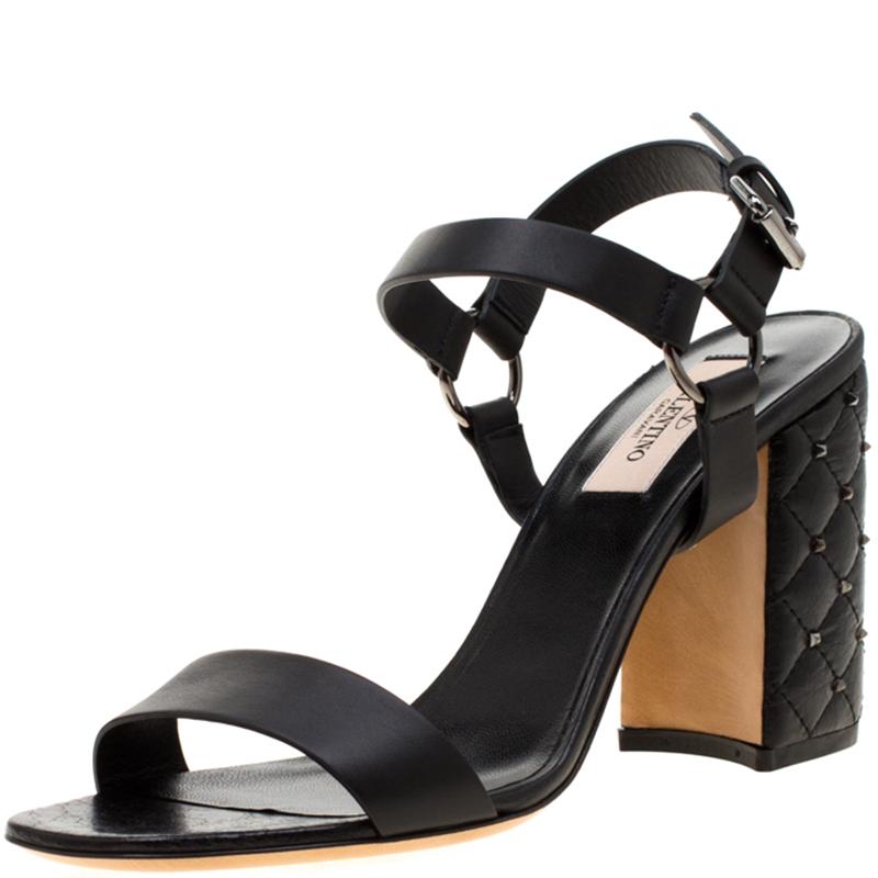 Simplicity is the ultimate sophistication, and these black block heel sandals remind you of exactly that. It is crafted impeccably from the finest leather and has an amazing rockstud design that sets it apart. They come with ankle straps. These