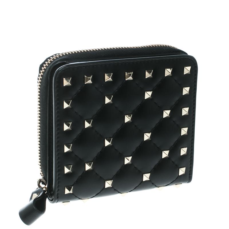 How lovely is this Valentino wallet! Every accent on it is appealing and high in style, like the signature studs on the quilted leather exterior and the zip around that reveals multiple compartments to house your things.

Includes: Original Dustbag,