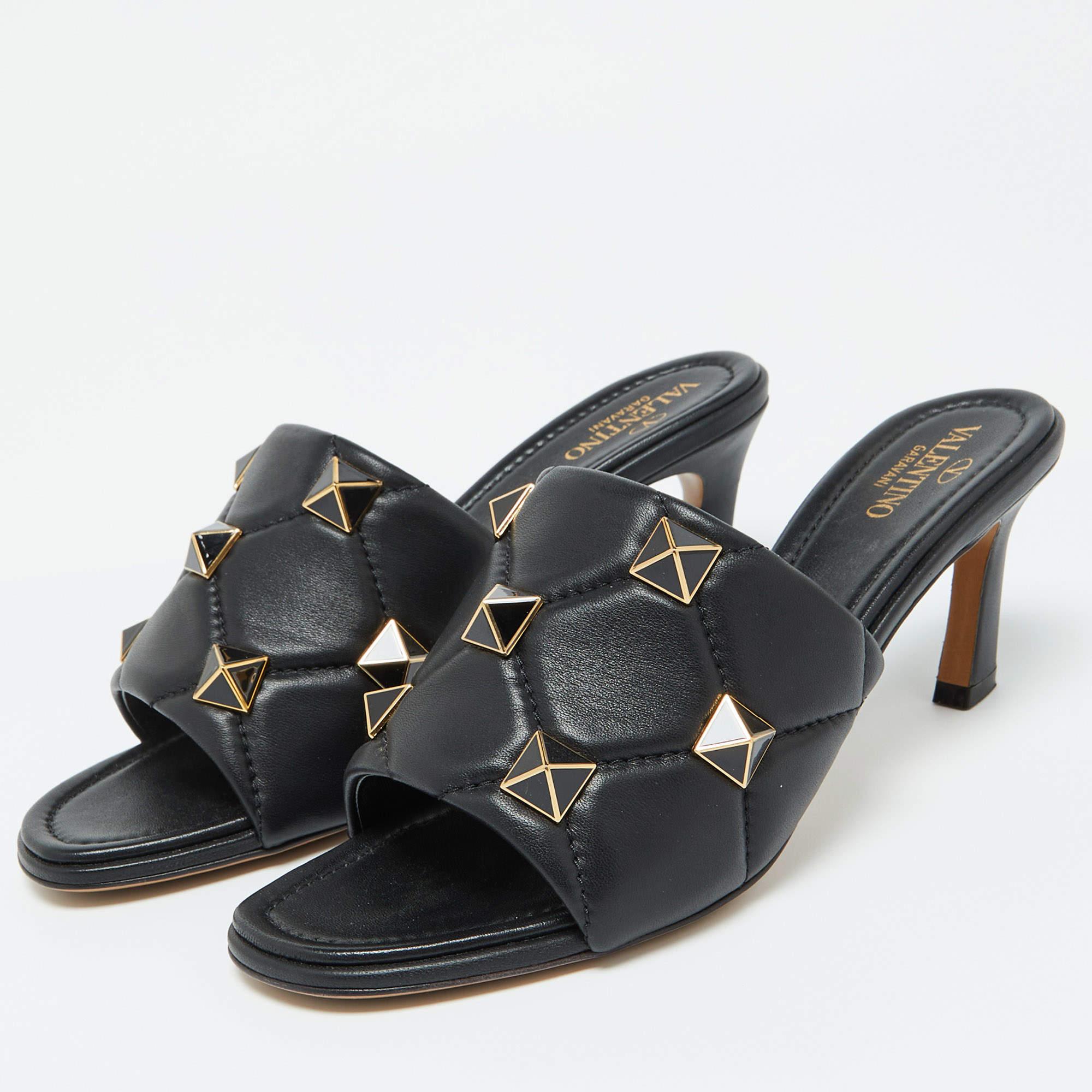 These Valentino slide sandals will be the eye catching element of your look when you walk in them. The broad straps have been quilted and adorn the carefully placed Roman studs a maximized version the signature house code Rockstuds.