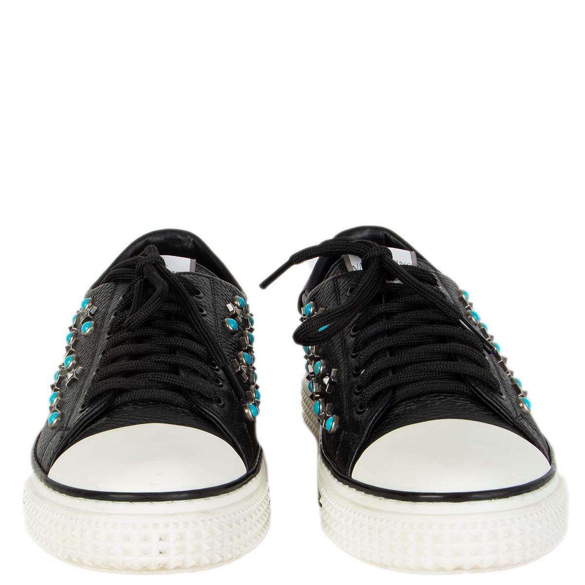 100% authentic  Valentino sneakers in black grained leather studded with metal stars and turquoise stones. White rubber sole and tip. Have been worn and are in excellent condition. Come with dust bag. 

Measurements
Imprinted Size	41
Shoe