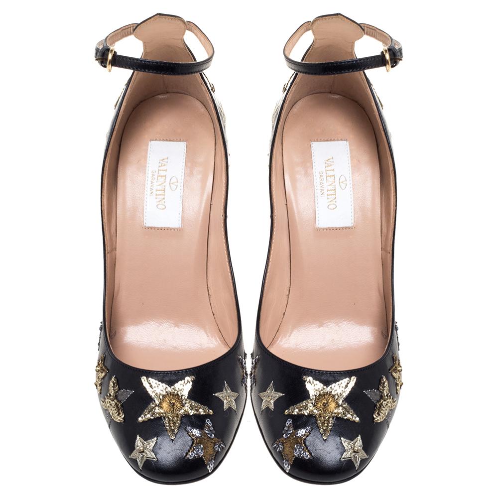 Crafted out of black leather, these Tango pumps have details of sequins stars. They feature covered toes, 9 cm heels, and buckle ankle straps. This stylish pair from Valentino will make a great addition to your collection.

Includes: Original