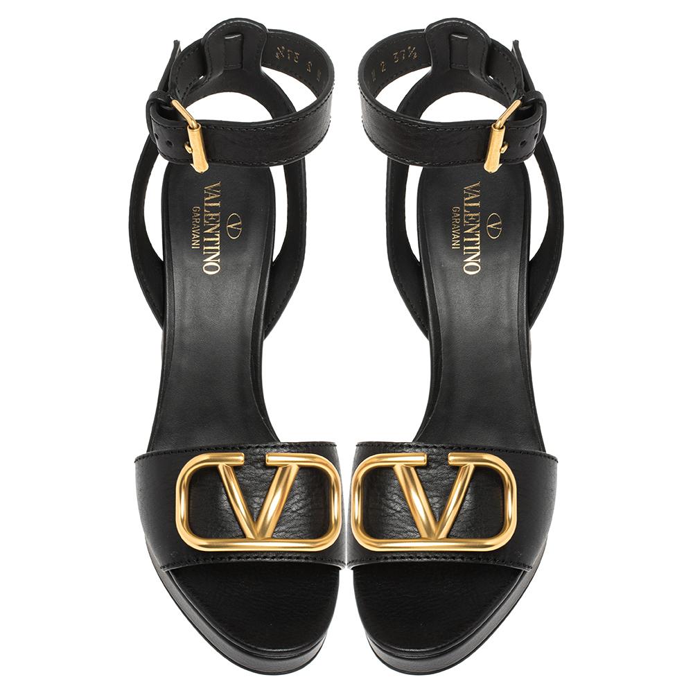 You'll find excuses to wear these gorgeous sandals from Valentino that are all about style and sophistication! These sandals are crafted from black leather into a fashionable design. They feature ankle strap fastening, block heels, and logo