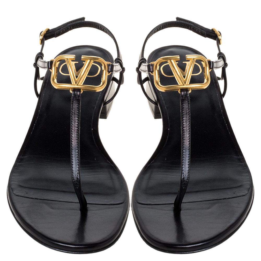 Valentino’s thong flat sandals are designed to deliver style, glamour, and an edge to your everyday style. Crafted in Italy, they are made from quality leather. They are styled with adjustable straps, buckle closures, and the signature V logo on the