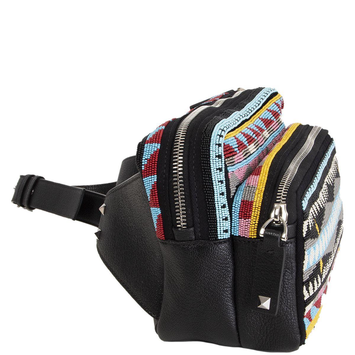 Valentino fanny pack embellished with multicolor beads on black canvas and leather featuring front zipper pocket. Opens with a zipper on top and is lined in black canvas. Belt strap is size L. Has been carried once and is in virtually new condition.