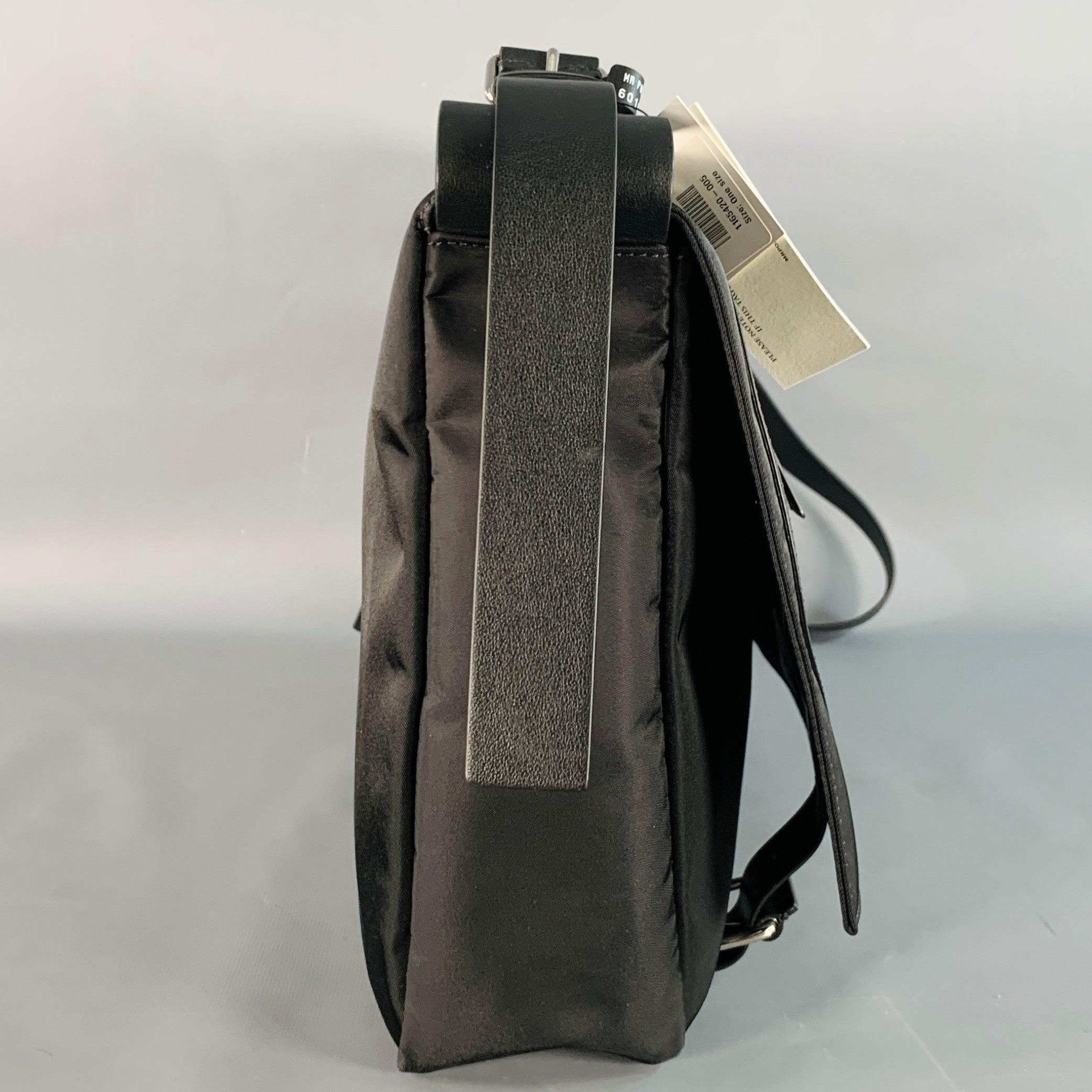 VALENTINO messenger bag
in a black nylon featuring tonal leather monogram front design, adjustable crossbody strap, and magnet closure.New with Tags. 

Measurements: 
  Length: 14.5 inches Width: 3.25 inches Height: 11.5 inches Drop: 21 inches 
  
