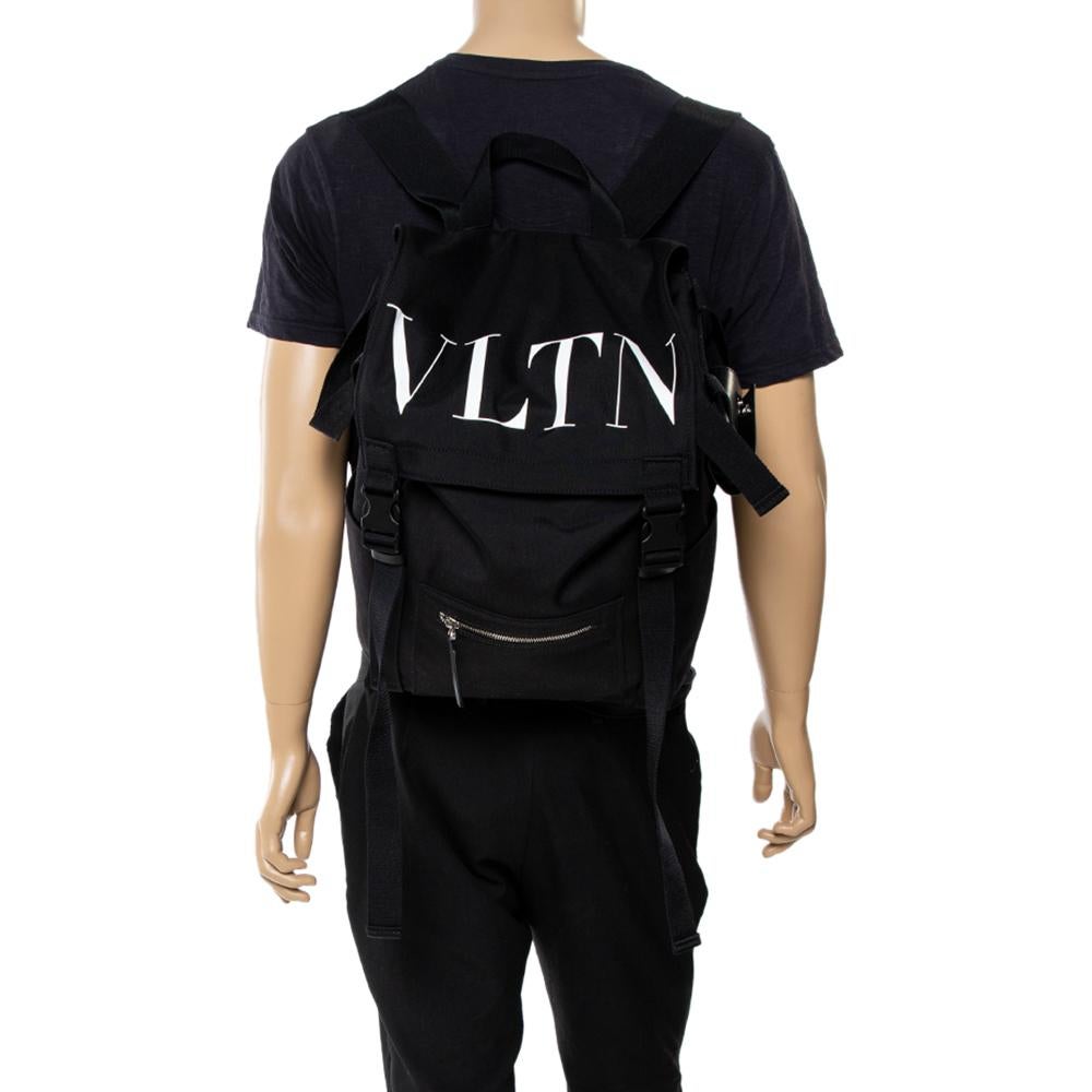 Your travel escapades or daily errands can now become more fun with this black backpack from Valentino! It comes crafted from nylon and features the signature 'VLTN' print on it. It has a front zip pocket and opens to a commodious interior that can