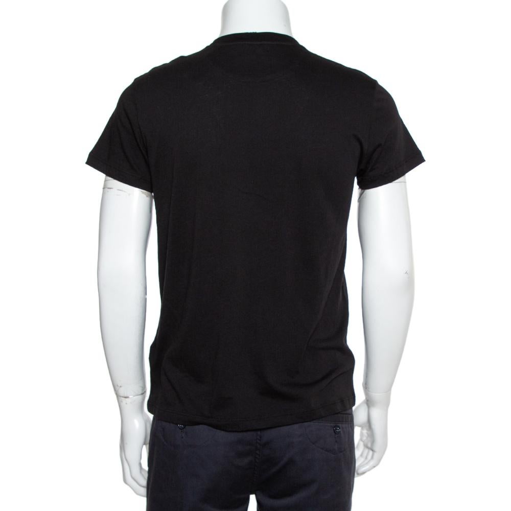 This Valentino men's T-shirt in black is cut for a relaxed fit and designed with a crew neckline, short sleeves, and prints on the front. You'll love the comfort and style this shirt brings.

Includes: Store tag