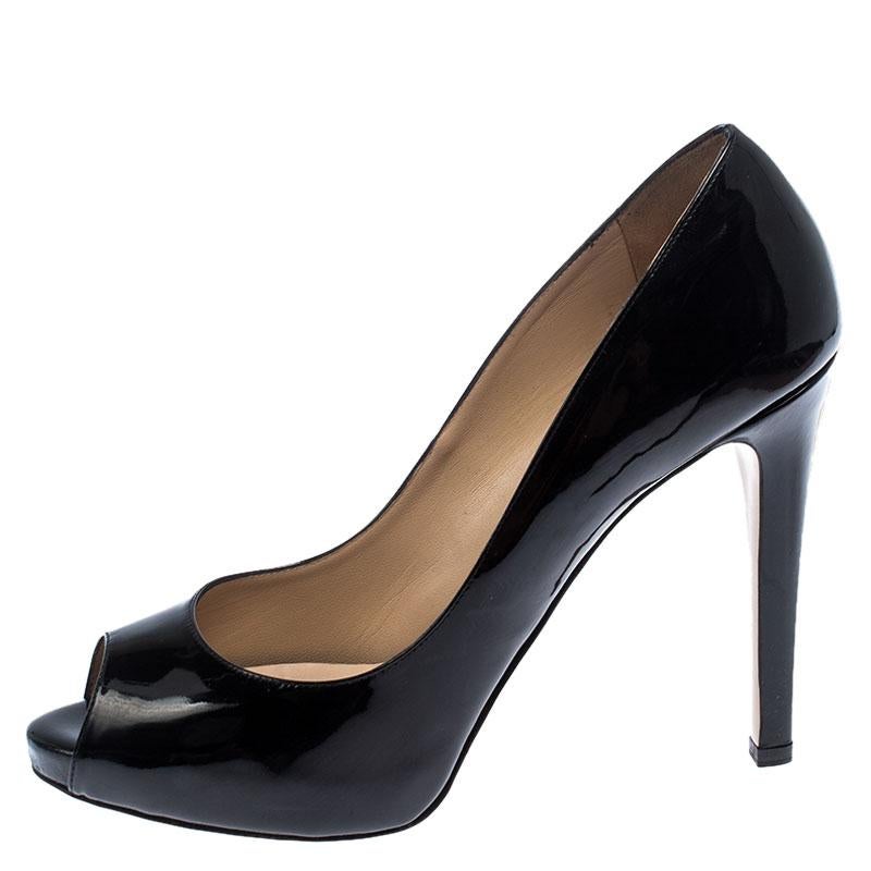 Known for romance-fused looks, these pumps come from the house of Valentino. Crafted in black patent leather, they feature peep toes and are accented with studs on the 12.5 cm high heels. They are complete with a glossy finish and leather lined