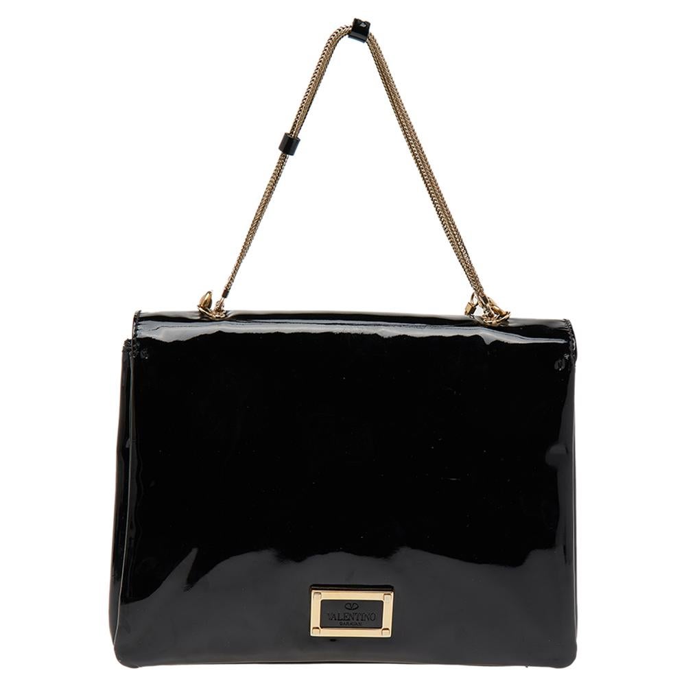 A classic bag like this one is absolutely necessary for every woman. This bag from Valentino completely suffices this necessity. Made with black patent leather and gold-toned accents, this shoulder bag perfectly manages to make your attire look