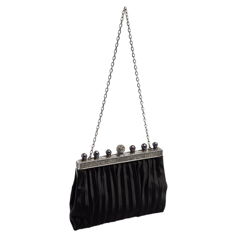 This clutch from Valentino is designed with satin and details of beads and crystals. It features a frame top and its satin interior is sized to hold your little essentials. It comes held by a chain and is perfect for evenings.

